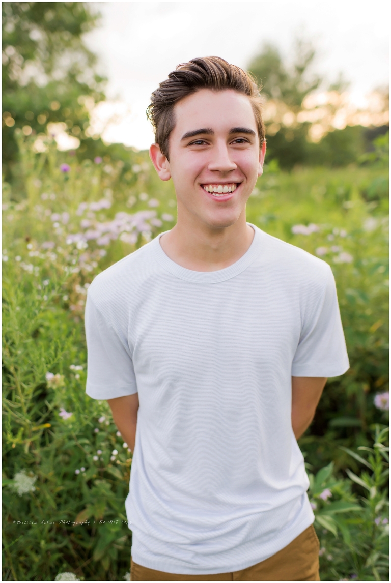 Senior high school guy outdoor photo session in grass Barrington Illinois